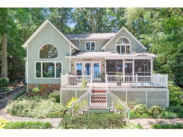 Charming two-story home with a large porch overlooking a lush landscape, ideal for outdoor living at 2704 Apache Trl, Denver, NC 28037