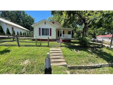 Charming home with a well-manicured front yard, fence, and inviting walkway at 300 Gurley St, Kannapolis, NC 28081