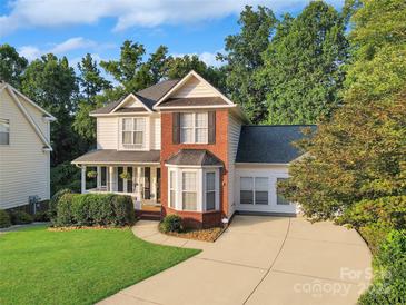 Charming two-story home with a welcoming front porch and a well-manicured lawn in a desirable neighborhood at 3705 Chesapeake Pl, Waxhaw, NC 28173