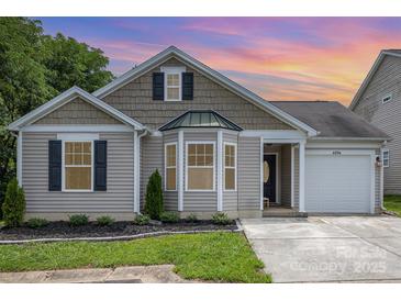 Charming single-Gathering home featuring manicured lawn, neutral siding, and attached one-car garage at 4894 Prowess Ln, Indian Land, SC 29707