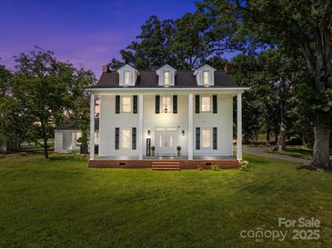 Beautiful two story traditional home with white siding, black shutters, and an inviting front porch at 550 Woodleaf Barber Rd, Cleveland, NC 27013
