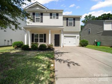 Charming two-story home with a welcoming front porch and attached one car garage at 8516 Paw Valley Ln, Charlotte, NC 28214