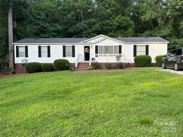 Charming single-story home with well-maintained lawn and inviting front porch at 1341 Pleasant Hill Church Rd, Wadesboro, NC 28170