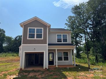 Two-story home featuring mixed siding, an attached garage, and a covered front porch at 1727 E Cloaninger Ave, Statesville, NC 28625