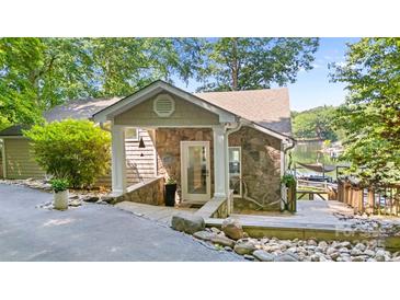 Inviting stone and siding facade with stylish entrance and stone walkway to the lake at 208 Island View Rd, Mount Holly, NC 28120