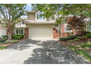 Two-story home with a two-car garage, manicured landscaping, and brick accents at 6602 Gaywind Dr, Charlotte, NC 28226