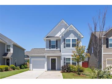 Charming two-story home features a well-manicured lawn and a classic architectural design under a clear blue sky at 12548 Gotland Rd # 327, Midland, NC 28107