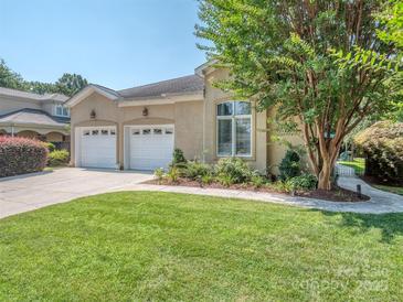 Stunning home with a lush green lawn, a charming tree, and a two-car garage, exudes curb appeal at 17709 Sedona Way, Cornelius, NC 28031