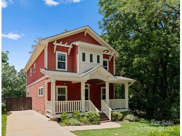 Charming two-story home with a welcoming front porch and landscaped yard, perfect for a Gathering at 423 Solomon St, Charlotte, NC 28216