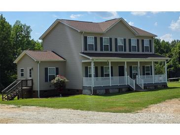 Charming two-story home featuring a welcoming front porch and well-maintained lawn at 550 Baker Mill Rd, Cleveland, NC 27013