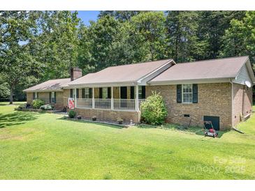 Charming brick ranch home with a large porch and lush lawn, perfect for outdoor living at 6601 Charlotte Hwy, York, SC 29745