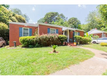 Charming brick home with a well-maintained lawn and blue shutters offers classic curb appeal at 3037 Marlowe Ave, Charlotte, NC 28208