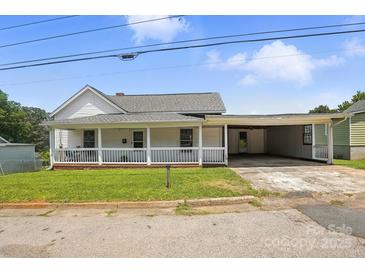 Charming home featuring a covered porch, a connected carport, and a well-maintained front lawn at 310 Sidney Johnson St, Fort Mill, SC 29715