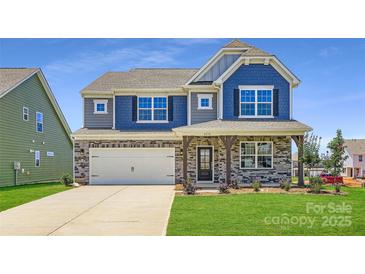 Charming two-story home featuring stone accents, a two-car garage, and a welcoming front porch at 4178 Skyboat Cir, Fort Mill, SC 29715