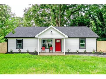 Charming home with a bright red door and a well-manicured front lawn at 9208 Detroiter Dr, Huntersville, NC 28078