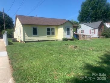 Charming single-story home with a welcoming front yard and classic architectural details at 1242 Mitchell Ave, Statesville, NC 28677
