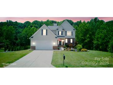 Charming two-story home with attached garage, lush lawn, and well-maintained landscaping at 139 Sheep Path Dr, Mooresville, NC 28115