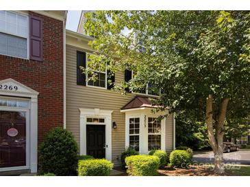 Charming townhome with black front door, bay window, and beautiful landscape at 2273 Aston Mill Pl, Charlotte, NC 28273