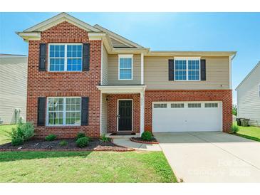 Charming two-story home featuring a brick facade, attached garage, and well-maintained front lawn at 2357 Riding Trail Rd, Gastonia, NC 28054
