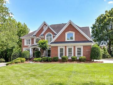Beautiful brick home with manicured lawn and mature landscaping creates a welcoming curb appeal at 27246 Preston Pl, Fort Mill, SC 29707