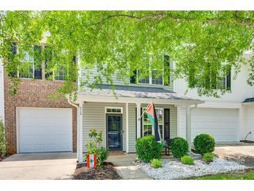 Charming two-story home with a quaint front porch and well-manicured landscaping at 713 Torrey Pines Ln, Fort Mill, SC 29715