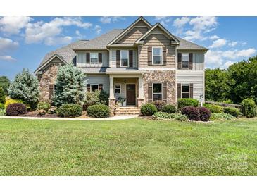 Charming home featuring stone accents, a landscaped front yard, and inviting curb appeal at 7805 Crooked Creek Church Rd, Monroe, NC 28110