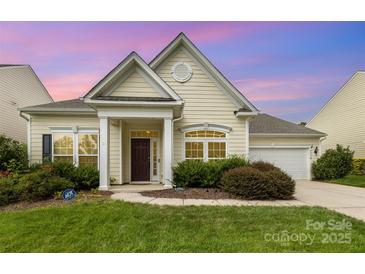 Charming single-story home featuring a well-manicured lawn, inviting entrance, and attached garage at 1116 Arnott Ln, Matthews, NC 28105