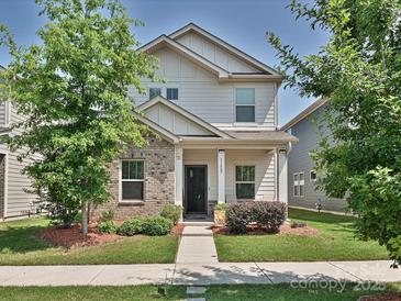 Charming two-story home featuring a blend of siding and brick, with a well-manicured lawn and sidewalk at 11807 Midnight Way, Huntersville, NC 28078