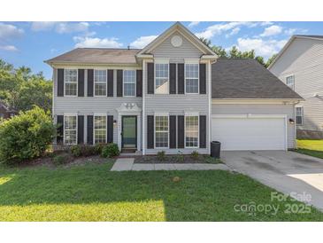 Charming two-story home with black shutters, green lawn, and attached two-car garage on a sunny day at 12250 Wallace Ridge Dr, Charlotte, NC 28269