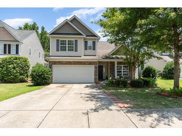 Charming two-story home with a two-car garage, brick accents, and well-manicured landscaping at 13510 Brandon Trail Dr, Charlotte, NC 28213