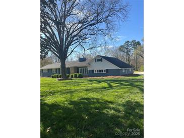 Charming single-story home featuring a lush green lawn, mature tree, and traditional architectural style at 188 Gum Branch Rd # 3, Charlotte, NC 28214
