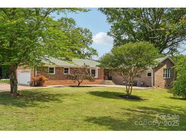 Charming brick home with a well-manicured front yard and mature trees, offering great curb appeal at 327 Johnson Dairy Rd, Mooresville, NC 28115
