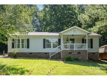Charming single-Gathering home with a cozy front porch and well-maintained lawn at 394 Link Dr, Iron Station, NC 28080