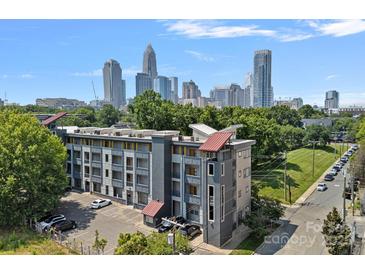 Wonderful exterior view of a modern apartment building with city skyline in background at 514 W 10Th St # 302, Charlotte, NC 28202