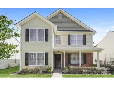 Charming two-story home with a well-manicured lawn and inviting front porch, perfect for enjoying the neighborhood at 1522 Tuckers Glenn Dr, Rock Hill, SC 29732