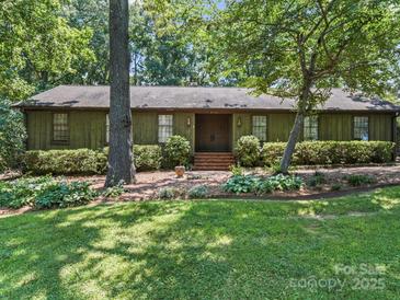 Charming one story home featuring beautiful landscaping and a welcoming entrance at 2104 Stoneyridge Dr, Charlotte, NC 28214