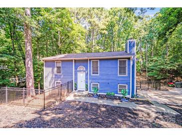 Charming blue two-story home with a fenced yard and mature trees, offering privacy and curb appeal at 2116 Bon Villa Way, Fort Mill, SC 29708