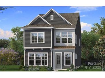 Charming two-story home boasts a symmetrical design, complemented by gray siding, and white trimmed windows at 3103 Middle St # 92, Charlotte, NC 28278
