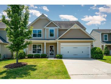 Charming two-story home with landscaped yard, mature trees, and attached two-car garage at 3816 Ernie Dr, Charlotte, NC 28269
