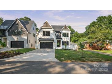 Striking two-story home with modern design, neat lawn, dark garage door, and paved driveway at 4349 Castleton Rd, Charlotte, NC 28211