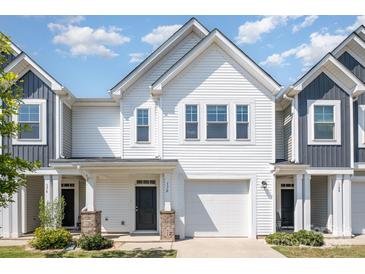 Charming two-story townhouse with white siding, garage, well-manicured lawn, and a covered porch at 172 Briana Marie Way, Indian Trail, NC 28079