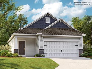 Charming single-story home featuring a two-car garage, a cozy front porch, and classic architectural details at 225 Runner Stone Ln, Fort Mill, SC 29715