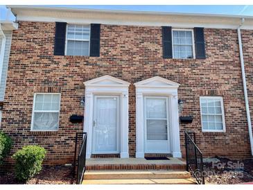 Charming brick townhome featuring black shutters and a well-maintained front entrance with white doors at 250 Nixon Rd # 41, Belmont, NC 28012