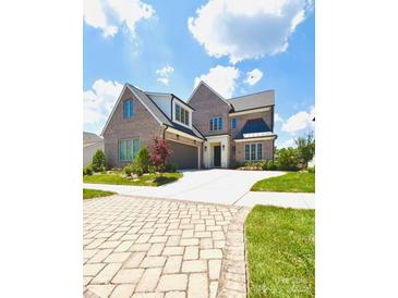 Beautiful brick two-story home with an attached garage and a spacious driveway under a bright sky at 3011 Ella Katherine Way, Charlotte, NC 28210