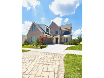 Beautiful brick home boasts manicured lawn, lush landscaping, and an expansive driveway at 3011 Ella Katherine Way, Charlotte, NC 28210