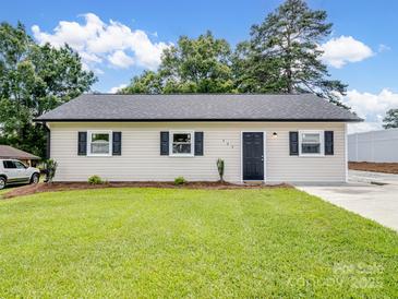 Charming single-story home with a well-manicured lawn, fresh landscaping, and a new roof at 405 Jones Street St, Monroe, NC 28110