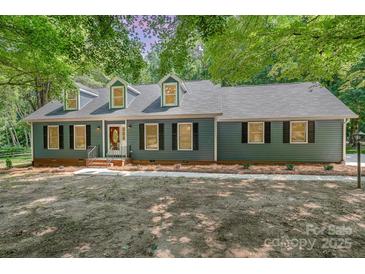 Charming home with a well-manicured lawn, complemented by mature trees and a welcoming facade at 133 Pecan Ln, Salisbury, NC 28146