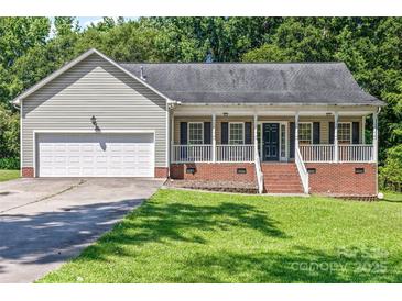 Charming single-story home with a welcoming front porch and attached garage at 1921 Williford Woods Ln, Rock Hill, SC 29730