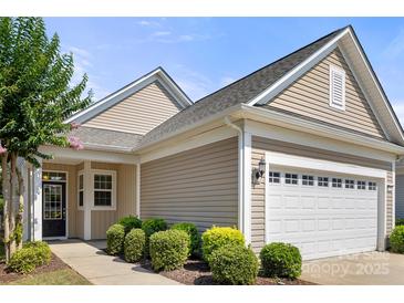 Charming single-story home with a well-manicured lawn and attached two car garage at 20241 Dovekie Ln, Indian Land, SC 29707