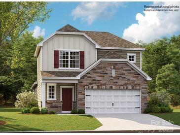 Charming two-story home featuring stone accents, a two-car garage, and a welcoming front entrance at 233 Runner Stone Ln, Fort Mill, SC 29715